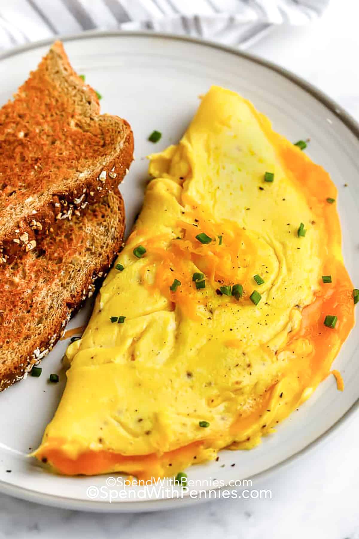 an omelette on a plate with toast