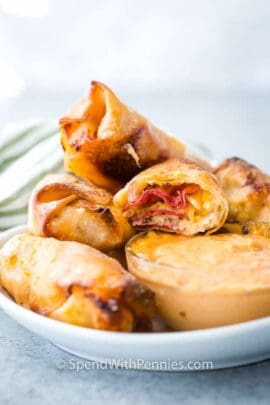 reuben egg rolls on a plate with dip