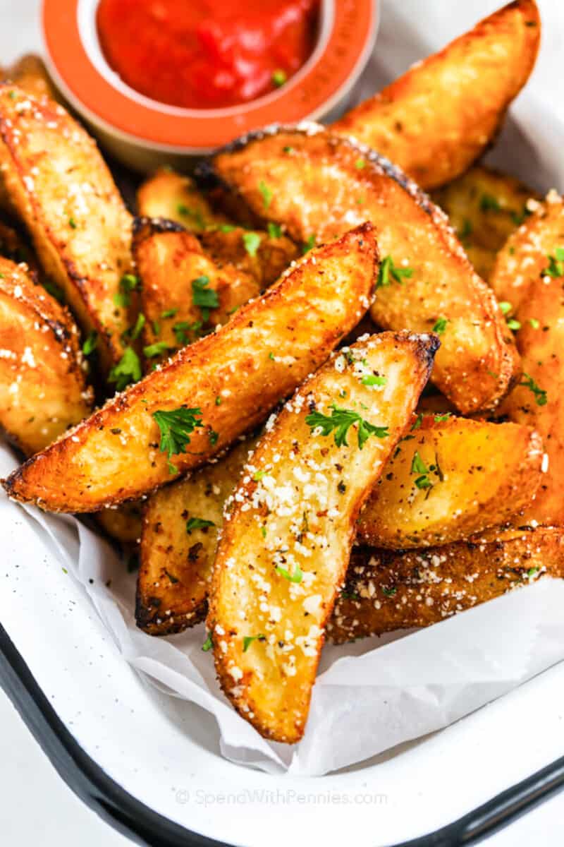 Air Fryer Potato Wedges topped with parsley and parmesan cheese