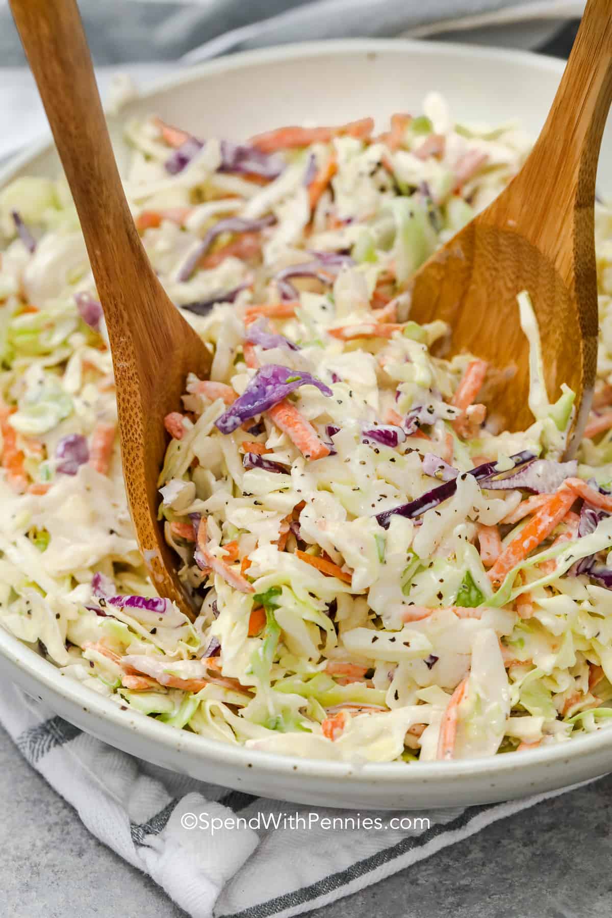 serving a coleslaw recipe with wooden spoons
