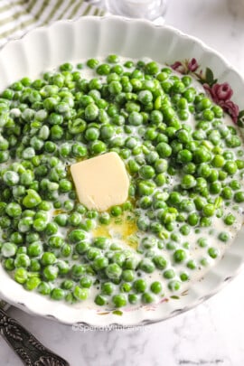 a bowl of creamed peas with butter