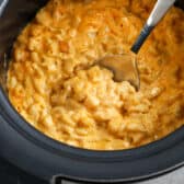 Crock Pot Mac and Cheese being served from a crockpot
