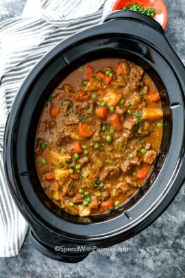 crockpot beef stew in a slow cooker garnished with parsley