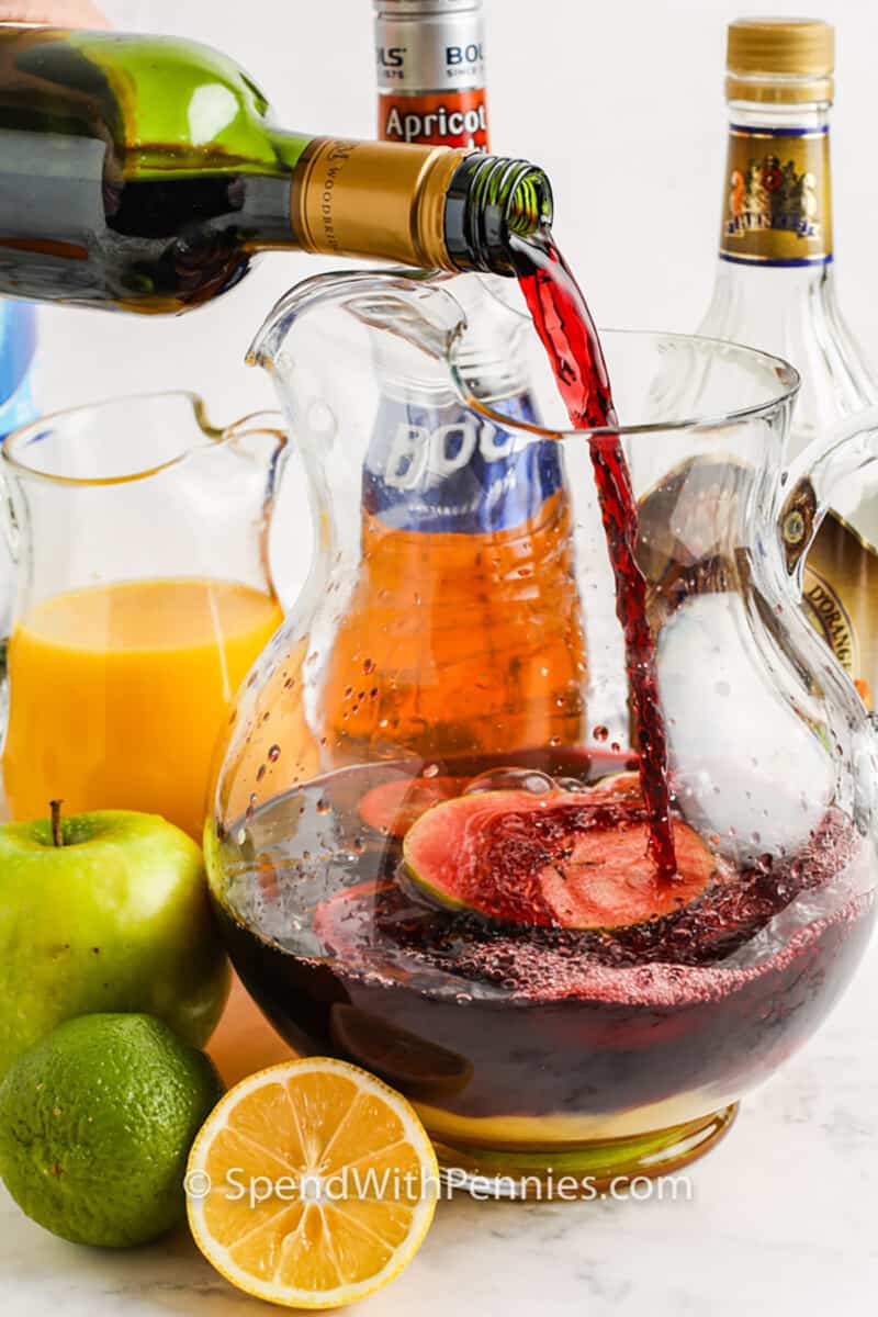 adding wine to jug to make Easy Red Sangria