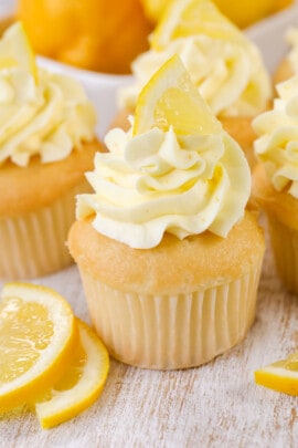 a cupcake topped with fresh lemon buttercream frosting