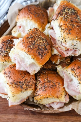 A pile of baked ham and cheese sliders