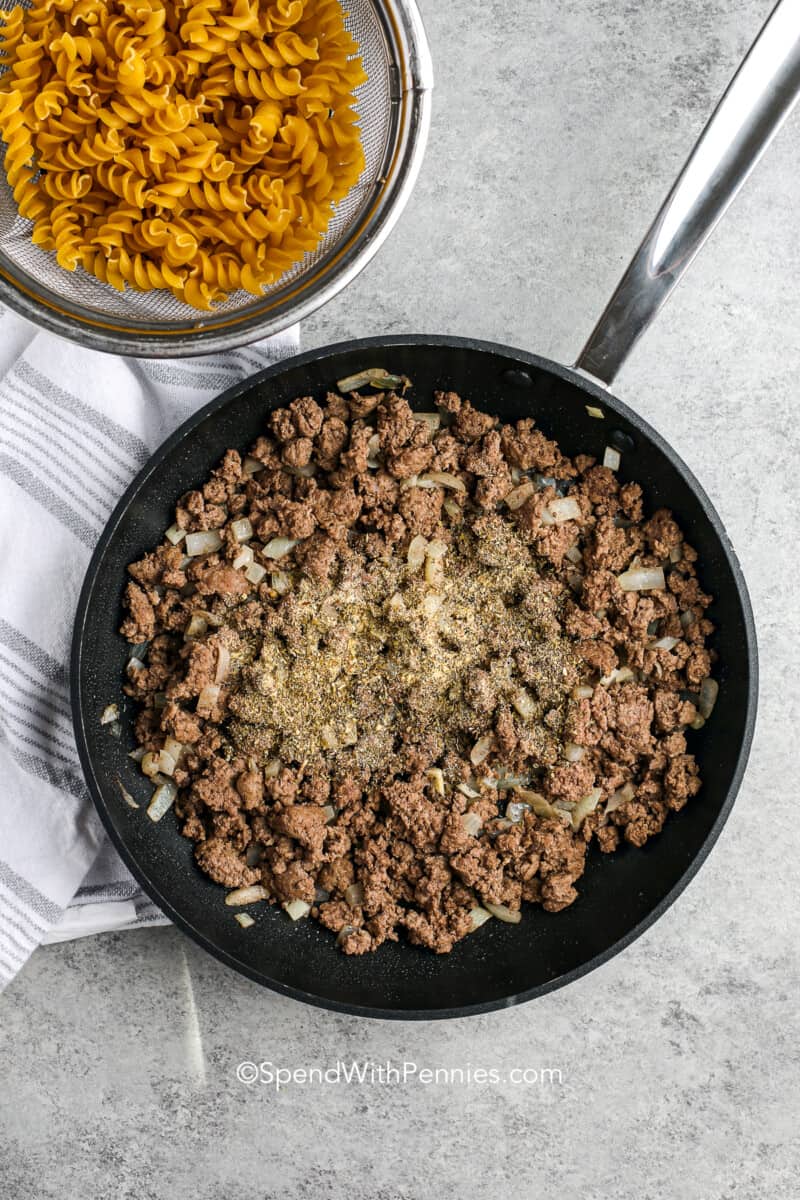 seasoning on ground beef in a skillet for hamburger casserole