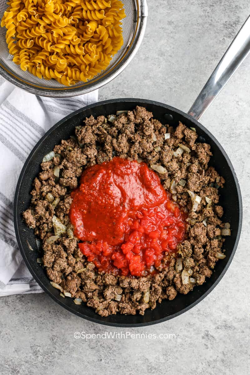 tomato sauce with ground beef in a skillet for hamburger casserole