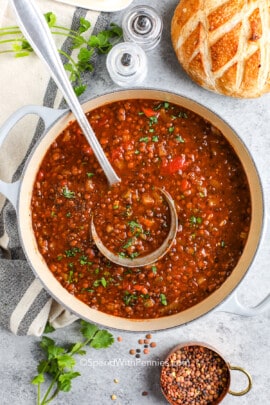 a pot of homemade lentil soup with a ladle