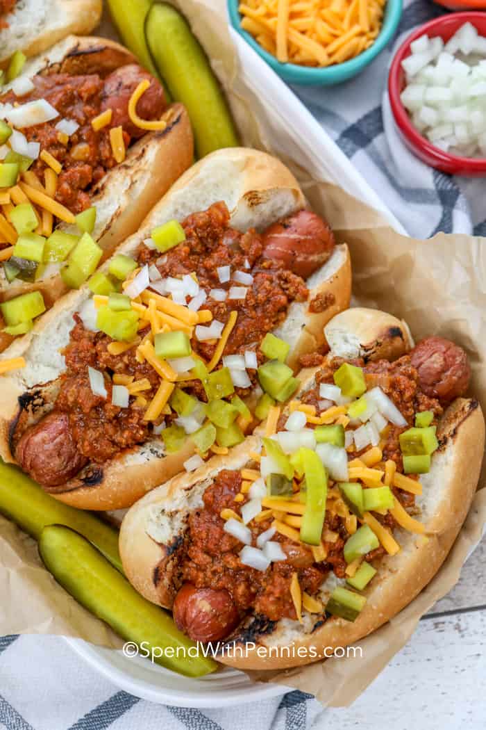 Overhead shot of hot dogs topped with chili sauce