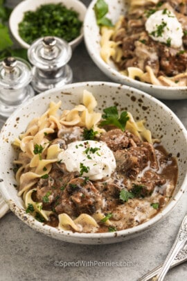 bowls of Instant Pot Beef Stroganoff with sour cream