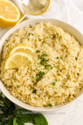 Lemon Orzo with garnish and lemon in a bowl