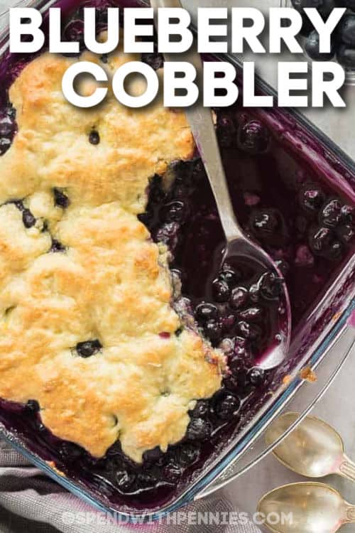 baked Blueberry Cobbler with a spoon and a title