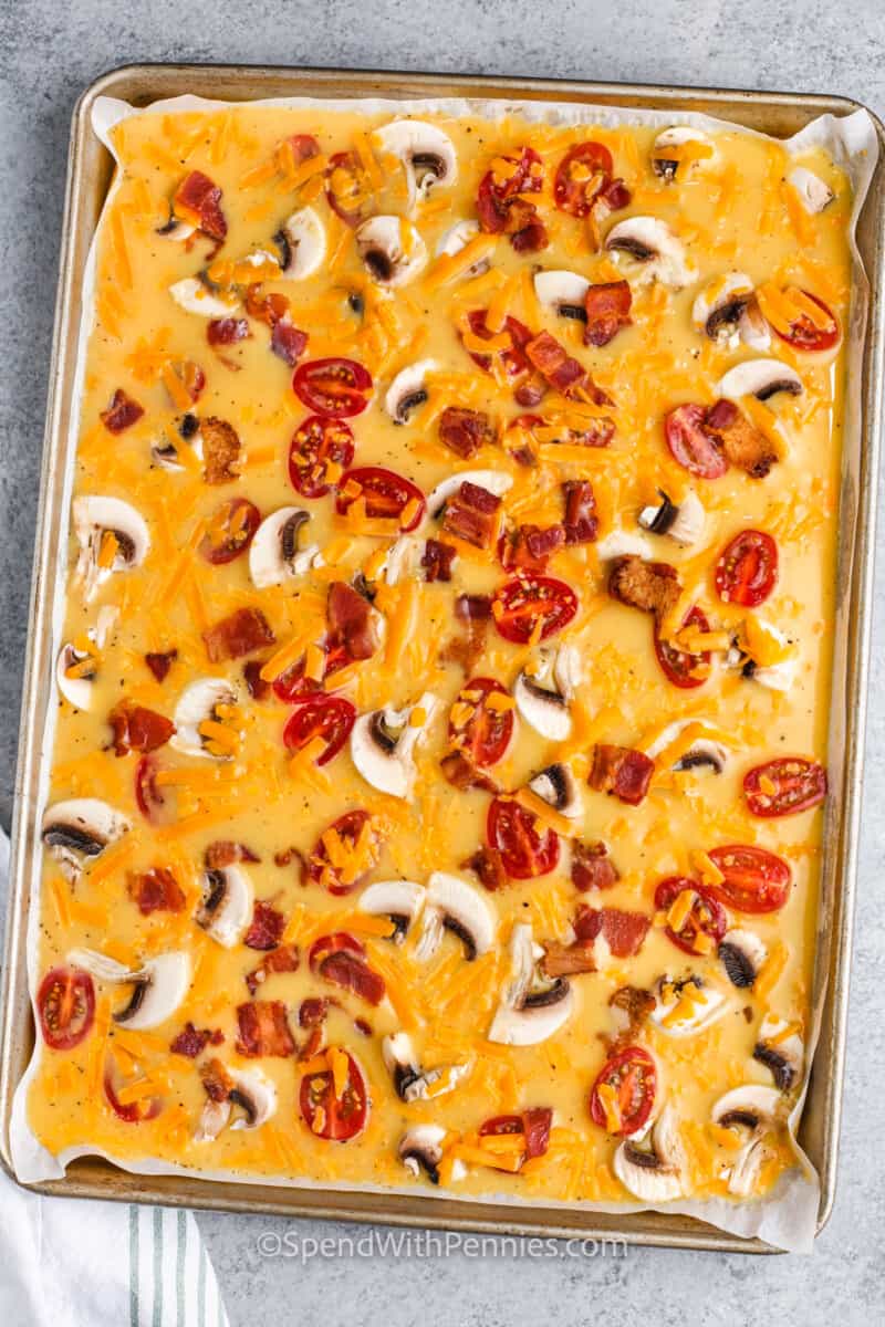 adding cheese to Sheet Pan Eggs in the pan