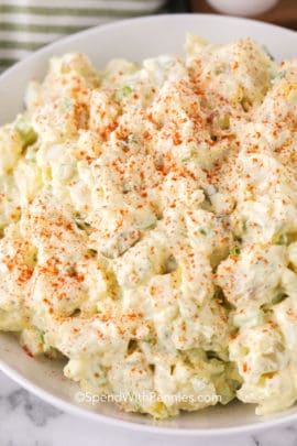 Southern potato salad in a white bowl with Paprika on top