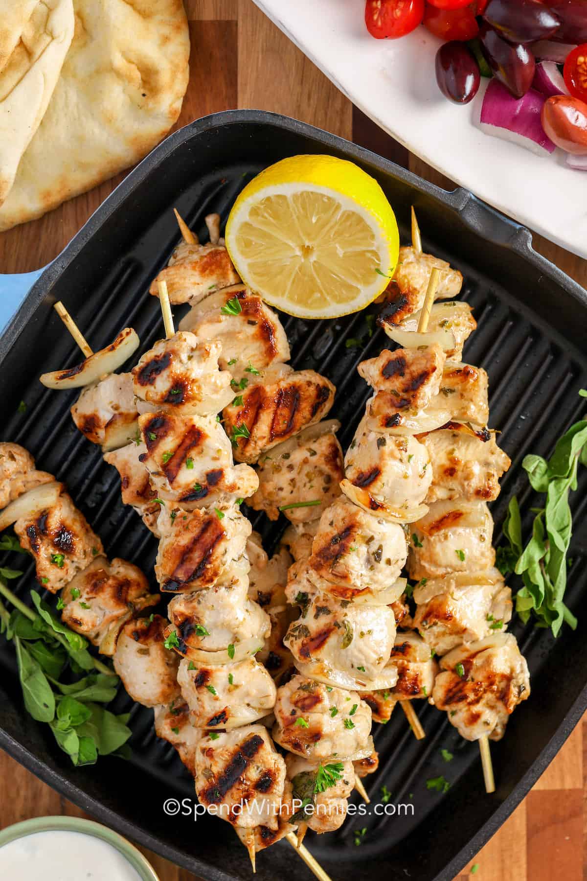 cooked chicken souvlaki on a grill pan