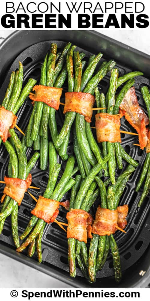 cooked Bacon Wrapped Green Bean Bundles in the air fryer with writing