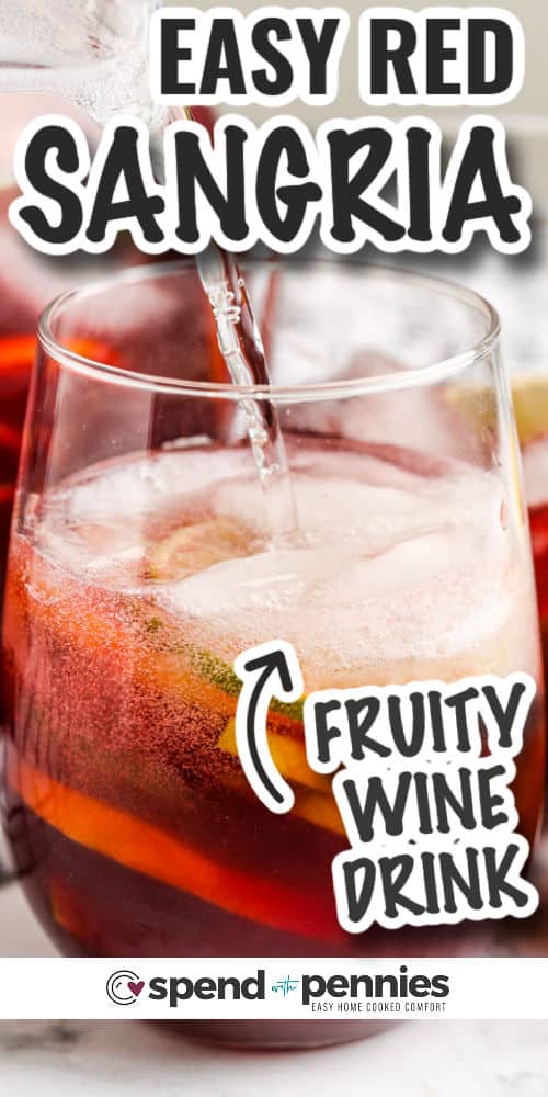 adding club soda to glass to make Easy Red Sangria with writing