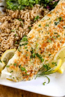 Parmesan Broiled Tilapia on a white plate with brown rice on the side
