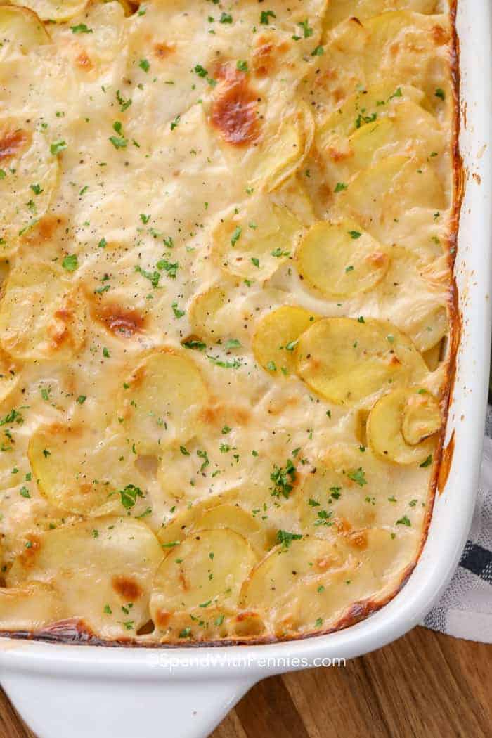 An overhead image of a pan of baked scalloped potatoes with parsley