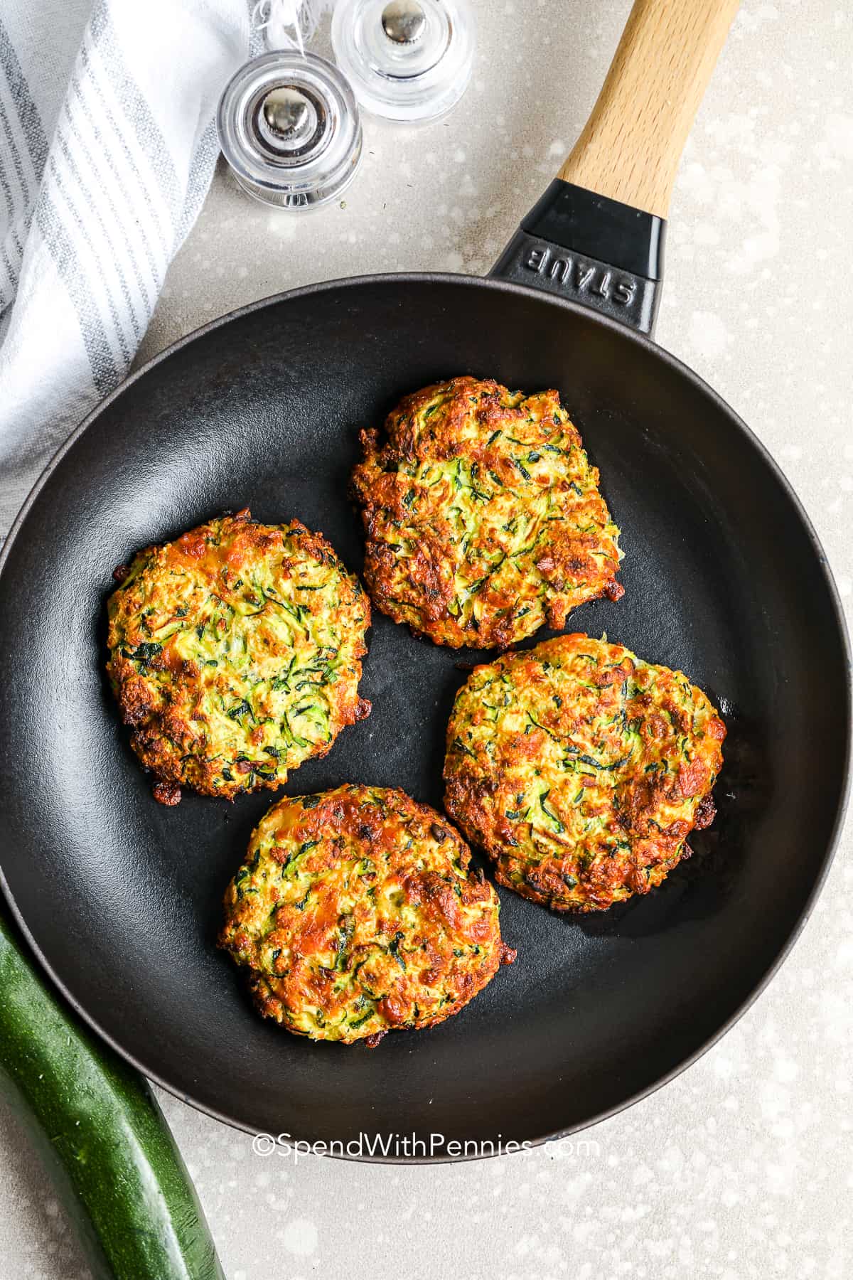 zucchini fritter patties in a skillet