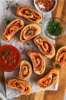 sliced Stromboli Recipe with garnish and dips