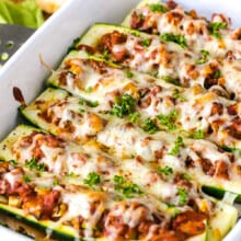 stuffed zucchini boats with baked cheese in a pan