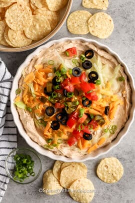 plated Easy Taco Dip with a bowl of chips beside it