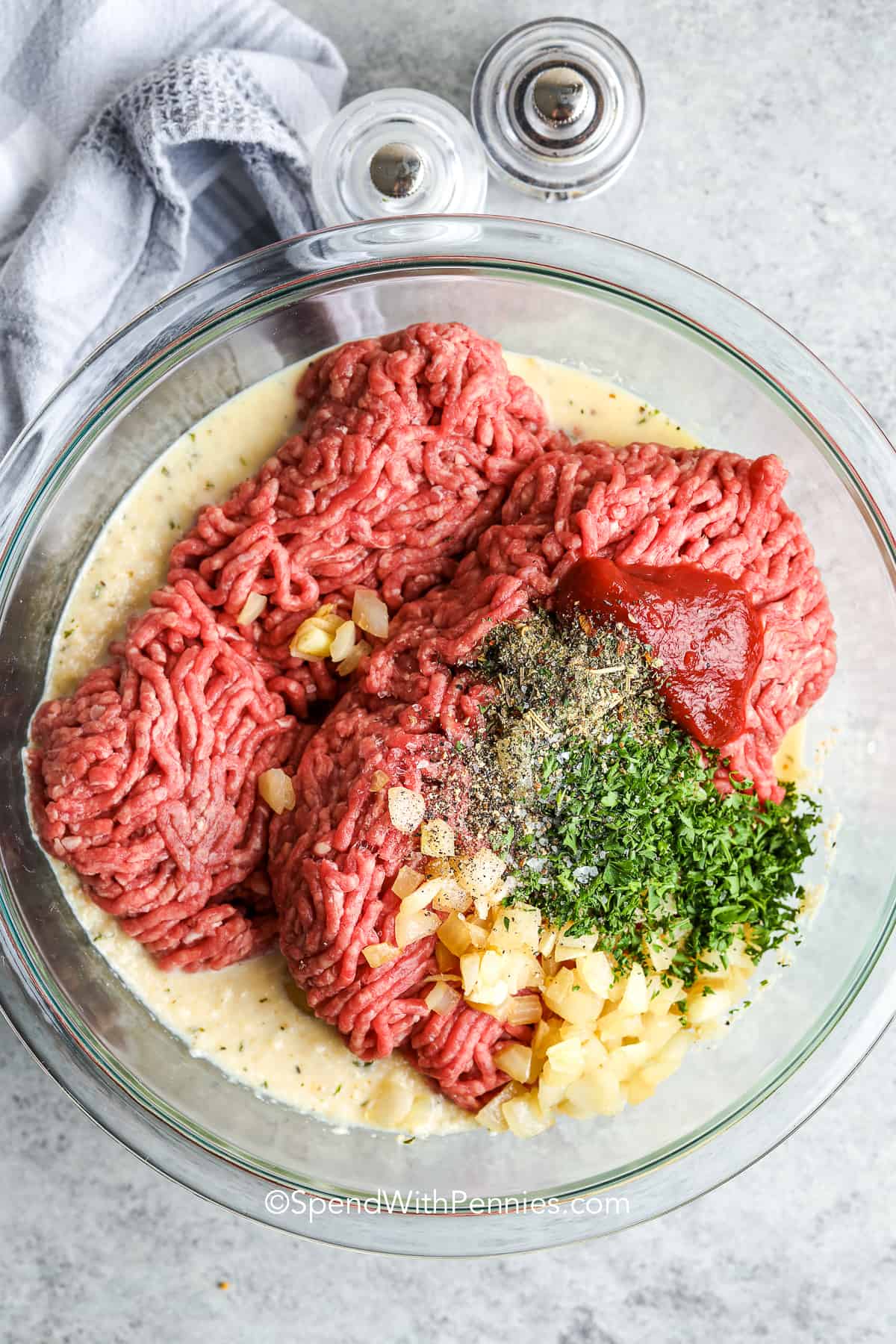 Ingredients in a glass bowl for a classic homemade meatloaf recipe